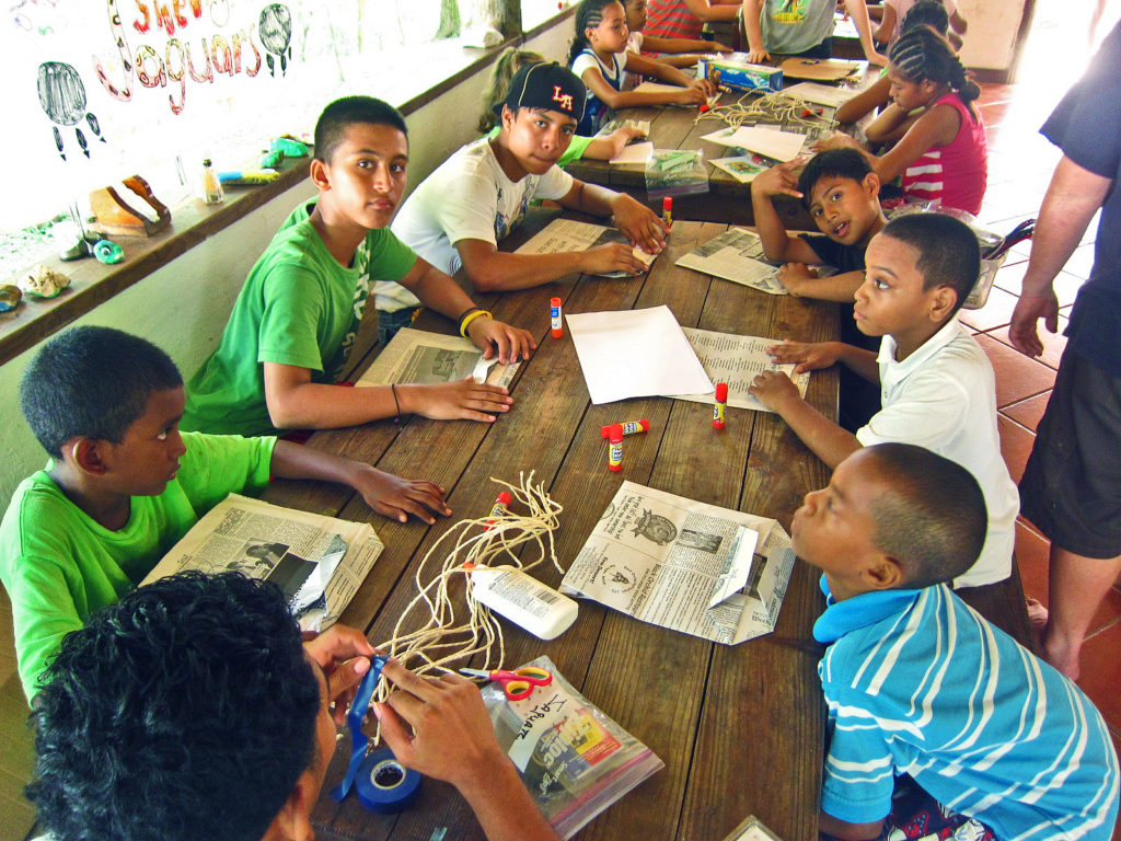 Boys putting together the newspaper bags