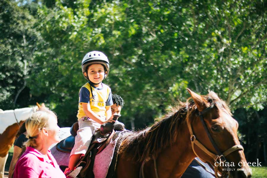 Child on horseback at Chaa Creek Belize