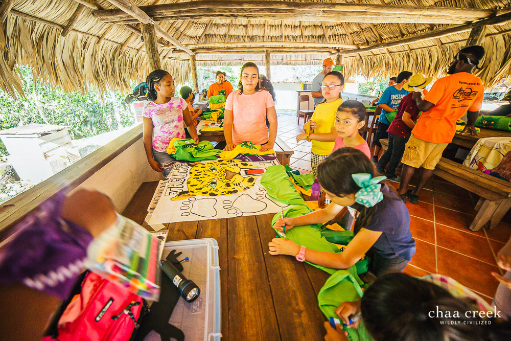 Eco Kids Summer Camp participants painting banners