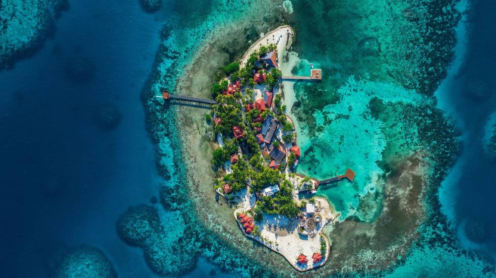 ray caye belize private island aerial photo honeymoon experience