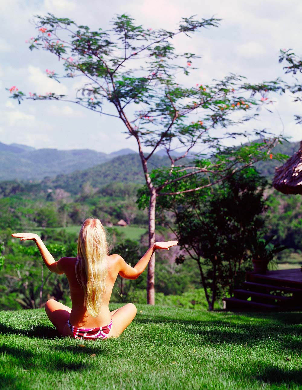 Woman meditating during yoga at Chaa Creek