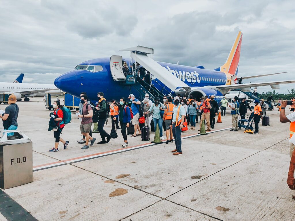 Passengers getting off a southwest airplane at belize's phillip goldson airport