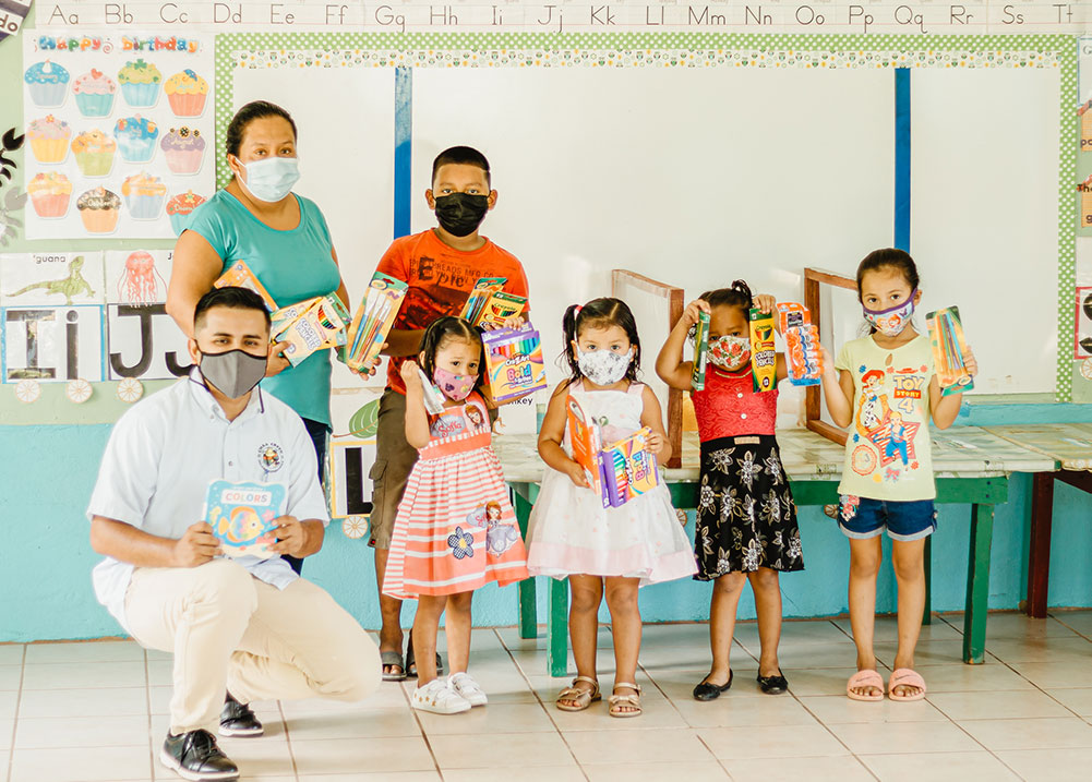 chaa creek delivering school supplies to preschool in rural village in belize
