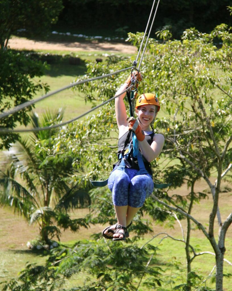 young kid ziplining in belize on family vacation