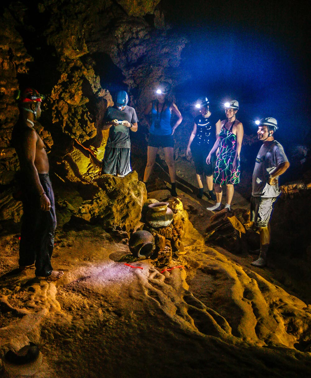 Maya artefacts inside actun tunichil muknal cave with visitors