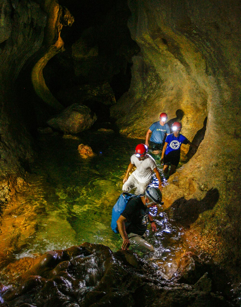 walking through the wet cave at actun tunichil muknal atm cave