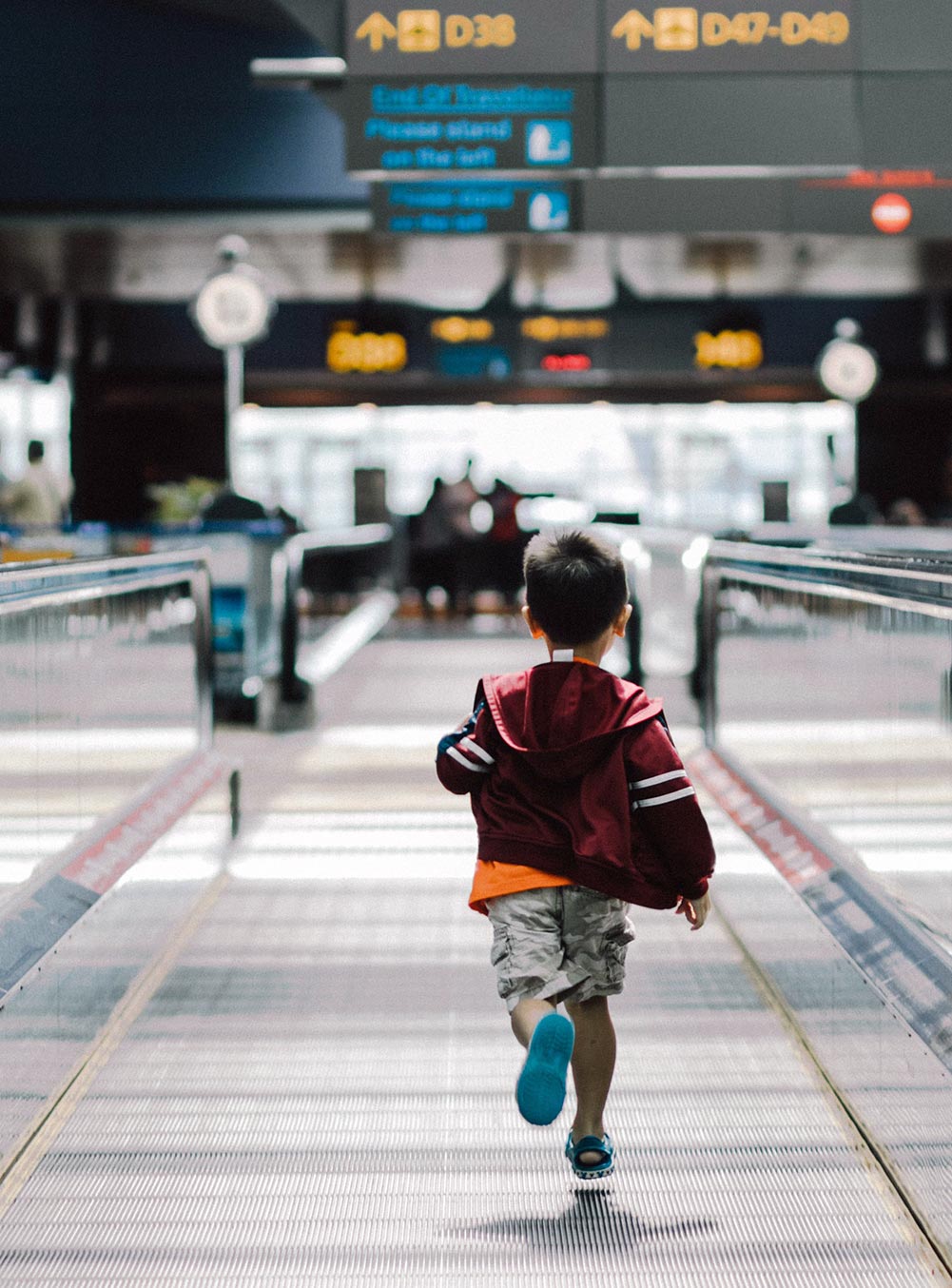 child running in airport going on belize vacation with grandparents