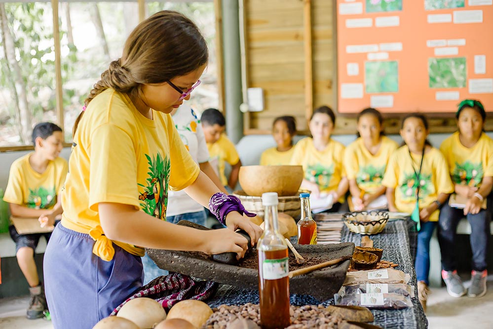 belize family vacation kid making maya chocolate